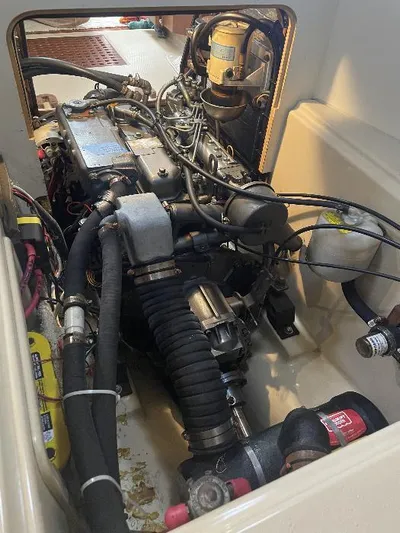  Yacht Photos Pics Engine compartment of a 1999 Island Packet 380 sailboat, showcasing mechanical components and wiring.