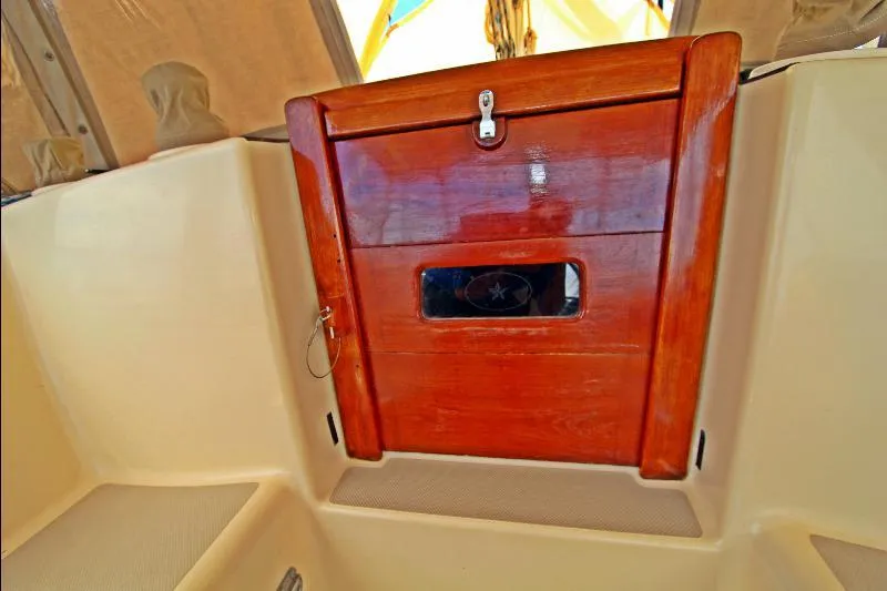  Yacht Photos Pics Wooden hatch door on 1999 Island Packet 380 sailboat, featuring polished finish and secure latch.