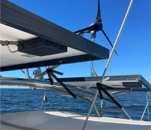  Yacht Photos Pics Solar panels and wind turbine on 1999 Island Packet 380 sailboat, ocean background.