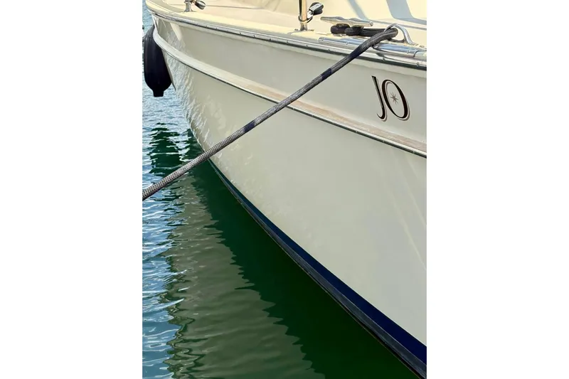  Yacht Photos Pics Island Packet 380 sailboat from 1999 docked on calm water.