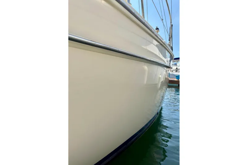  Yacht Photos Pics Side view of a 1999 Island Packet 380 sailboat docked in calm waters.