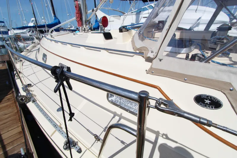  Yacht Photos Pics 1999 Island Packet 380 sailboat docked, showcasing deck and railing details.