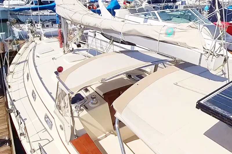  Yacht Photos Pics 1999 Island Packet 380 sailboat docked at marina, showcasing deck and rigging.