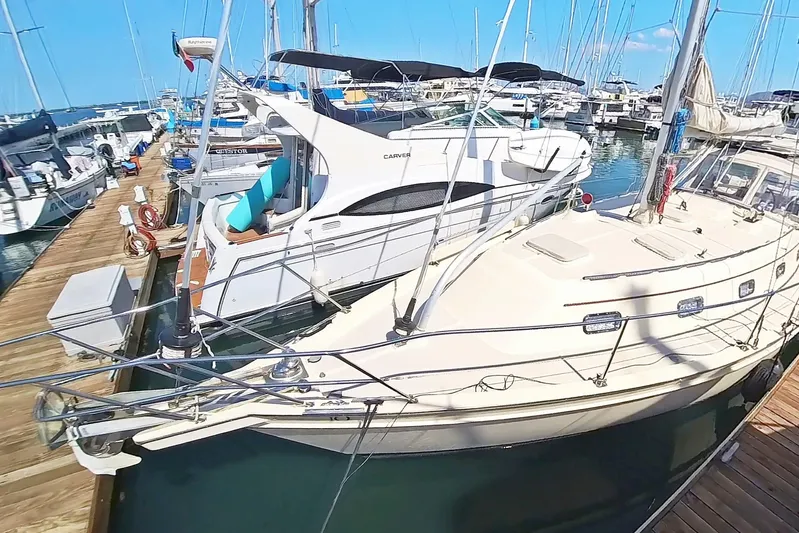  Yacht Photos Pics Sailboats docked at marina, featuring 1999 Island Packet 380 model.