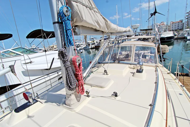  Yacht Photos Pics 1999 Island Packet 380 sailboat docked in a marina, showcasing deck and rigging.