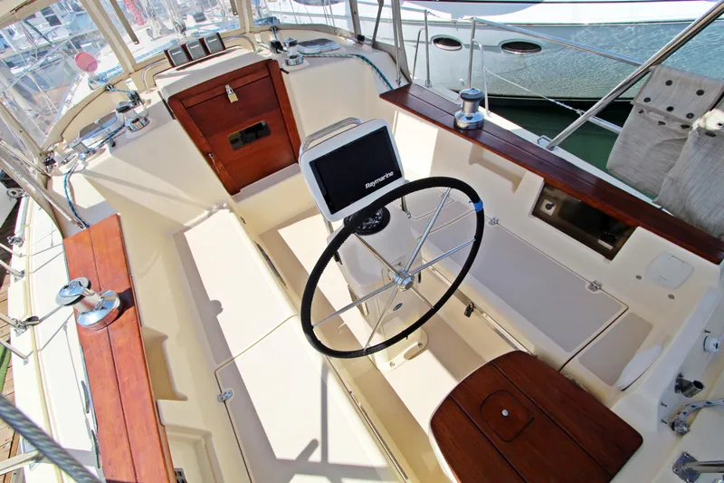  Yacht Photos Pics 1999 Island Packet 380 sailboat cockpit with steering wheel and navigation equipment.