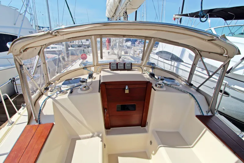  Yacht Photos Pics 1999 Island Packet 380 sailboat cockpit with wood accents and marina view.