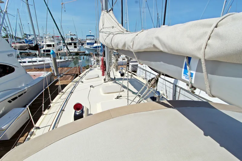  Yacht Photos Pics 1999 Island Packet 380 sailboat docked in a marina, surrounded by other boats.