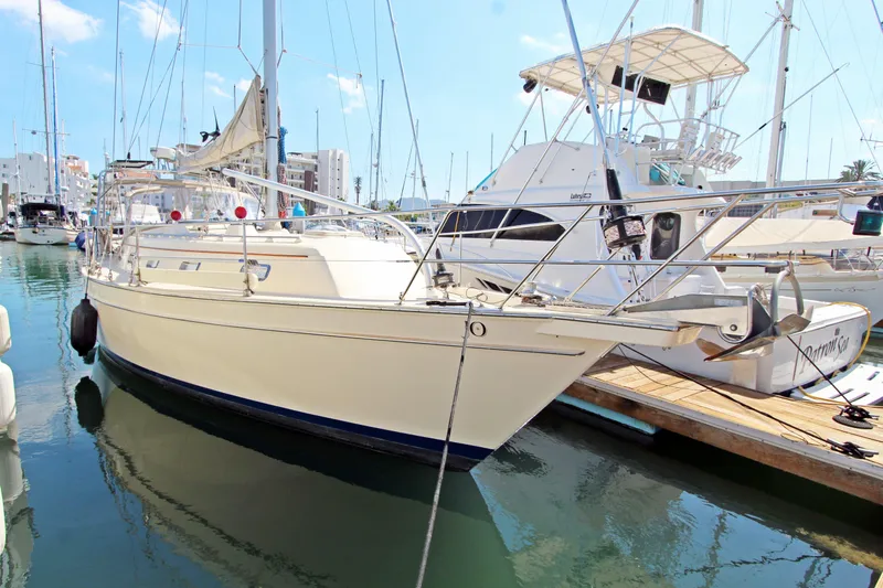  Yacht Photos Pics 1999 Island Packet 380 sailboat docked in a marina, sunny day, clear sky.