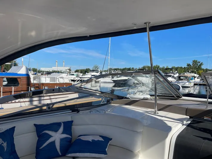  Yacht Photos Pics 2005 Regal Commodore 4260 yacht interior with marina view, featuring blue nautical pillows.