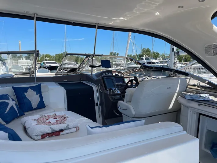  Yacht Photos Pics Luxurious 2005 Regal Commodore 4260 yacht interior with plush seating and modern dashboard.