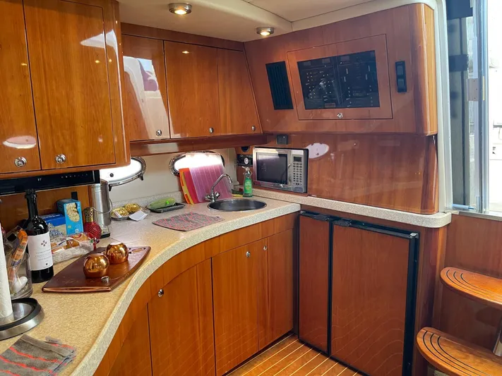 Yacht Photos Pics Luxurious 2005 Regal Commodore 4260 yacht kitchen with wood cabinetry and modern appliances.