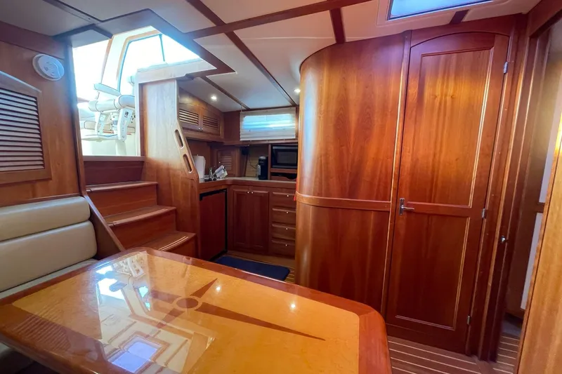 Ocean Breeze Yacht Photos Pics 2008 Sabre 38 Salon Express interior with wooden cabinetry, stairs, and dining area.