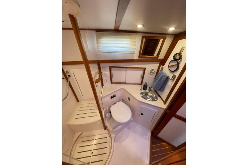 Ocean Breeze Yacht Photos Pics 2008 Sabre 38 Salon Express bathroom with shower, sink, and wooden accents.