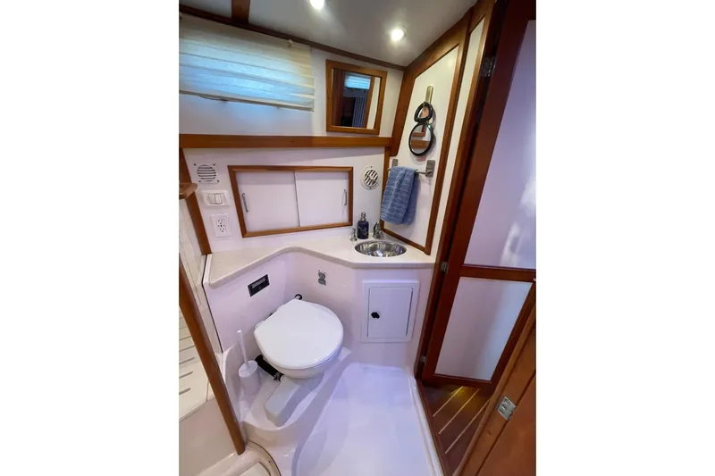 Ocean Breeze Yacht Photos Pics 2008 Sabre 38 Salon Express bathroom with toilet, sink, and wooden accents.