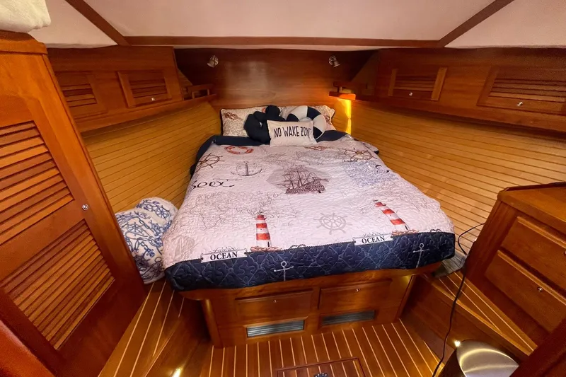Ocean Breeze Yacht Photos Pics Cozy cabin interior of 2008 Sabre 38 Salon Express with nautical-themed bedding.