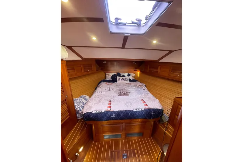 Ocean Breeze Yacht Photos Pics Cozy cabin interior of 2008 Sabre 38 Salon Express with nautical-themed bedding.