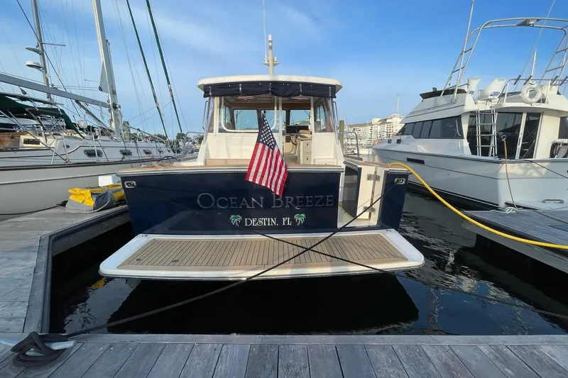 Ocean Breeze Yacht Photos Pics 2008 Sabre 38 Salon Express yacht docked, displaying "Ocean Breeze" and American flag.
