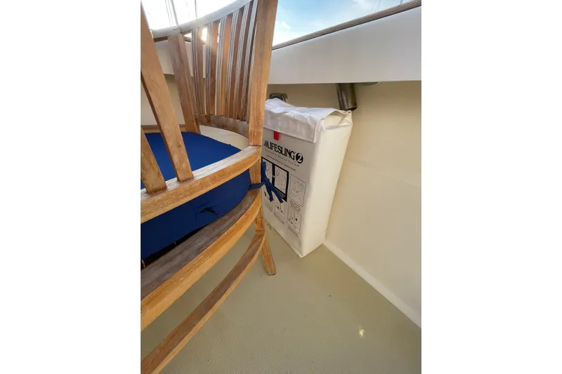 Ocean Breeze Yacht Photos Pics Wooden chair and life raft on 2008 Sabre 38 Salon Express yacht deck.