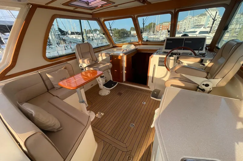 Ocean Breeze Yacht Photos Pics Interior of 2008 Sabre 38 Salon Express yacht with elegant seating and helm station.