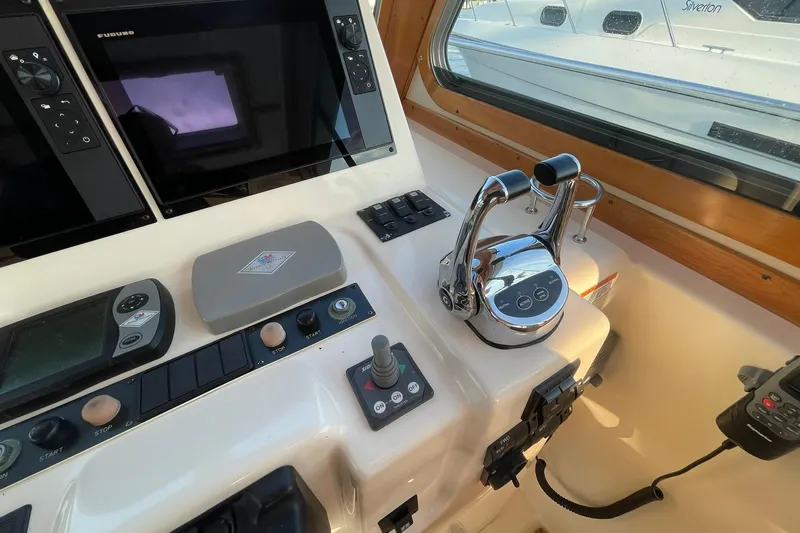 Ocean Breeze Yacht Photos Pics Control panel of 2008 Sabre 38 Salon Express yacht with navigation equipment and throttle levers.