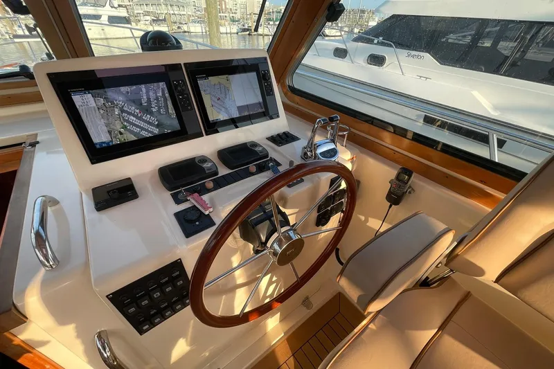 Ocean Breeze Yacht Photos Pics Helm of 2008 Sabre 38 Salon Express with dual navigation screens and wooden steering wheel.