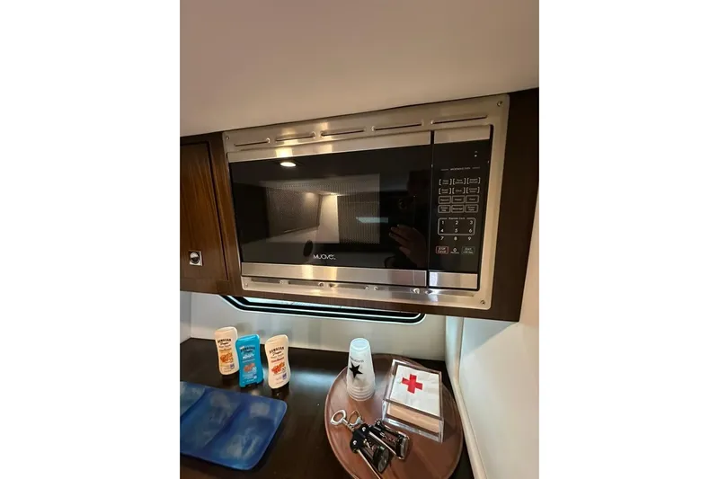  Yacht Photos Pics Microwave and essentials inside 2021 Cruisers Yachts 338 South Beach Edition Bow Rider.
