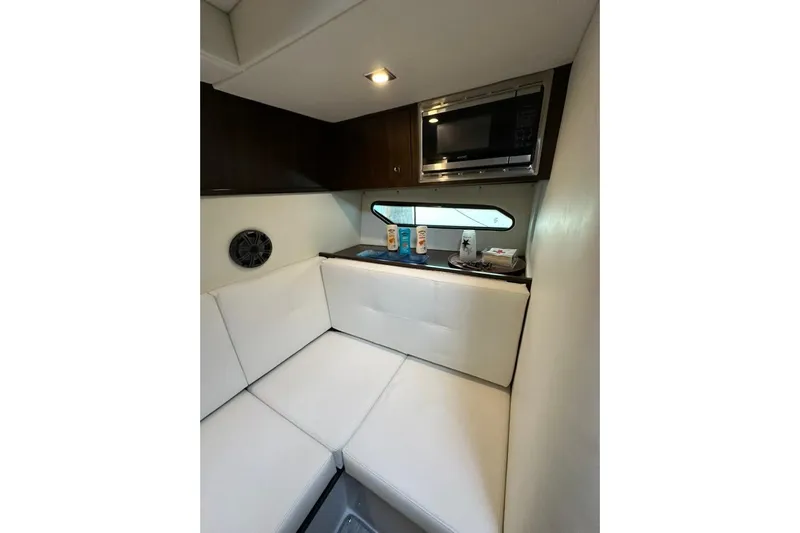  Yacht Photos Pics Interior of 2021 Cruisers Yachts 338 South Beach Edition, featuring cozy seating and a microwave.
