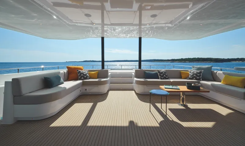  Yacht Photos Pics Luxurious 2025 Silent 60 yacht interior with ocean view, featuring elegant seating and decor.