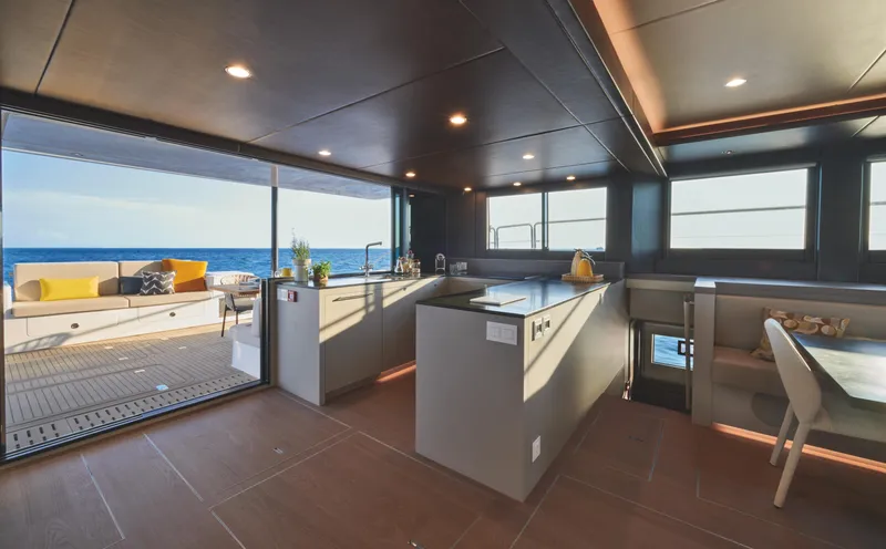 Yacht Photos Pics Luxurious interior of 2025 Silent 60 yacht with modern kitchen and ocean view.