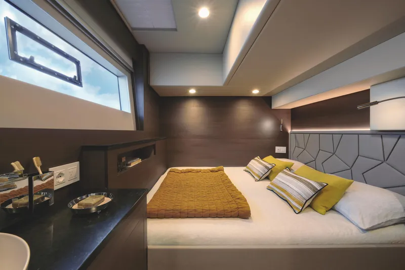 Yacht Photos Pics Luxurious bedroom interior of 2025 Silent 60 yacht with modern design and cozy bedding.