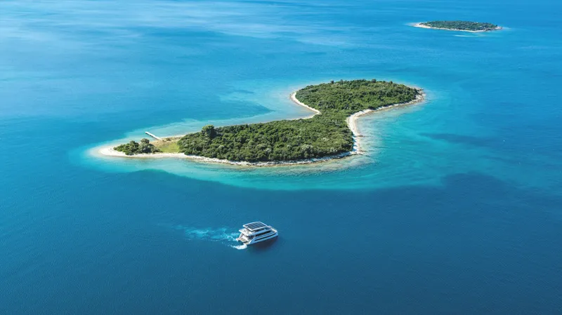  Yacht Photos Pics Silent 60 yacht near tropical island, 2025 model, cruising in clear blue waters.