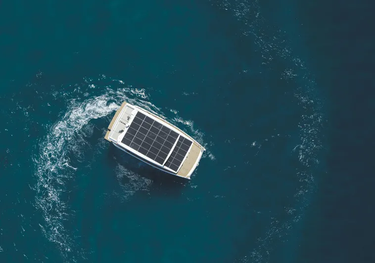  Yacht Photos Pics Aerial view of 2025 Silent 60 yacht with solar panels on blue ocean.