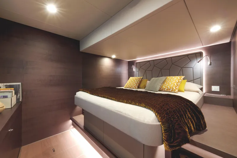  Yacht Photos Pics Luxurious bedroom interior on Silent 60 yacht, 2025 model, with modern lighting and cozy bedding.