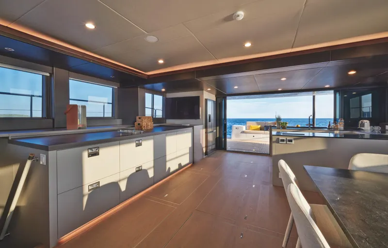  Yacht Photos Pics Luxurious interior of 2025 Silent 60 yacht with modern kitchen and ocean view.