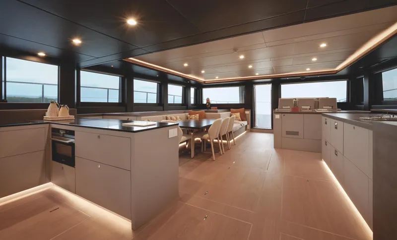  Yacht Photos Pics Luxurious interior of 2025 Silent 60 yacht with modern kitchen and dining area.