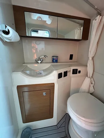Swallow Yacht Photos Pics 2017 Cruisers Yachts 338 Sport Series bathroom with sink, mirror, and toilet.
