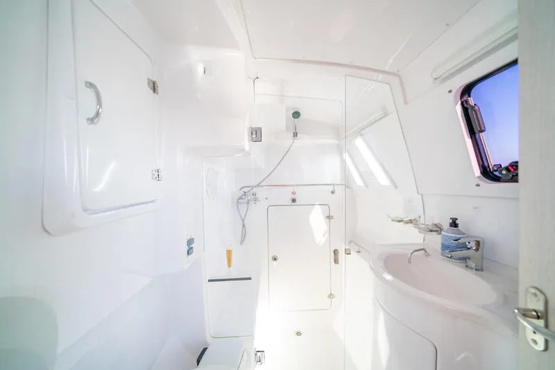 Sugarloaf Yacht Photos Pics 2023 Seawind 1160 Lite yacht bathroom with shower, sink, and window.