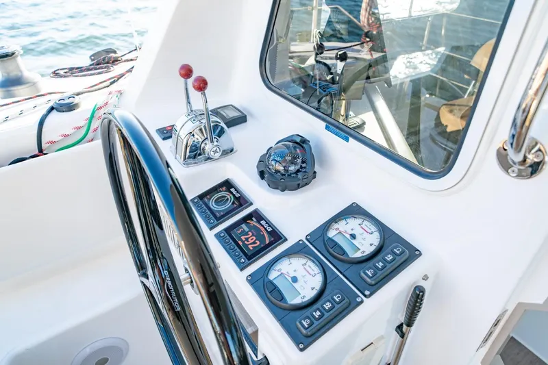 Sugarloaf Yacht Photos Pics 2023 Seawind 1160 Lite cockpit with steering wheel, controls, and navigation instruments.