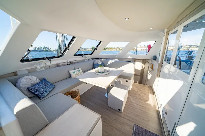 Sugarloaf Yacht Photos Pics Spacious interior of 2023 Seawind 1160 Lite catamaran with modern seating and panoramic windows.