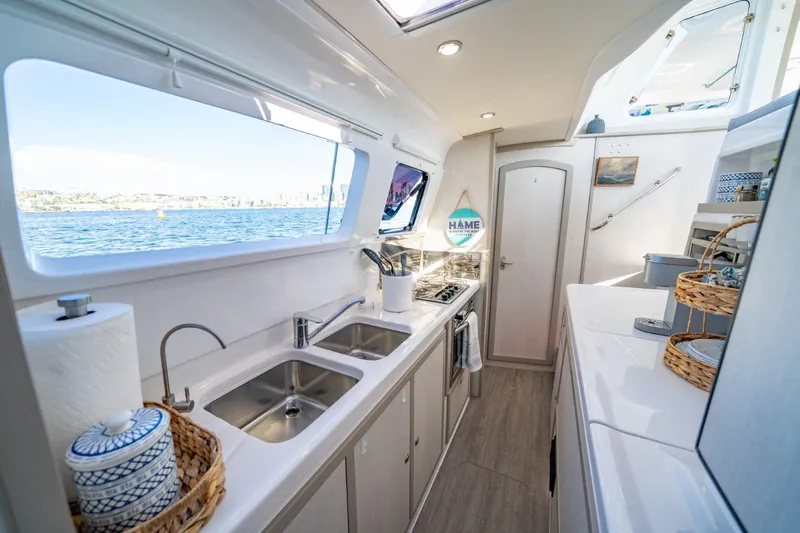 Sugarloaf Yacht Photos Pics Modern kitchen interior of 2023 Seawind 1160 Lite catamaran with ocean view.