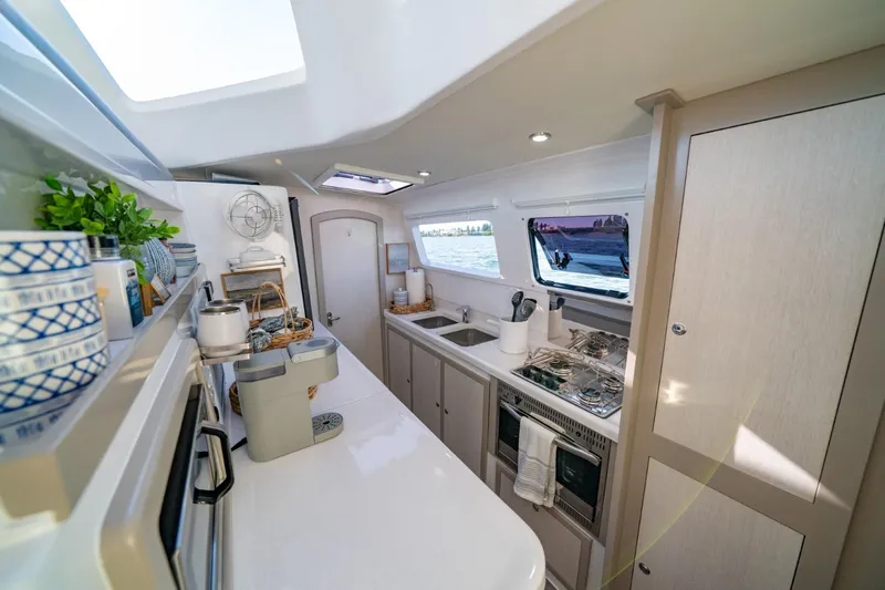 Sugarloaf Yacht Photos Pics Modern kitchen interior of 2023 Seawind 1160 Lite catamaran, featuring sleek design and ocean view.
