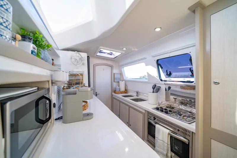 Sugarloaf Yacht Photos Pics Modern kitchen interior of 2023 Seawind 1160 Lite catamaran, featuring sleek appliances and ample counter space.