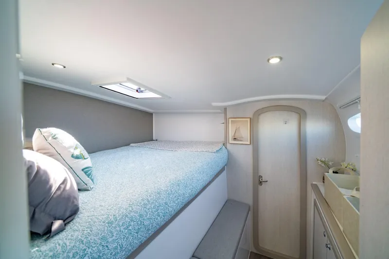 Sugarloaf Yacht Photos Pics Cozy bedroom interior of 2023 Seawind 1160 Lite catamaran with skylight and modern decor.