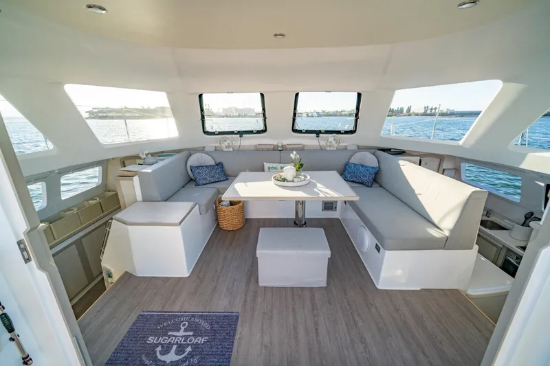Sugarloaf Yacht Photos Pics Luxurious interior of 2023 Seawind 1160 Lite catamaran with spacious seating and ocean view.
