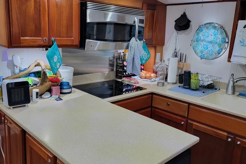 No Good Deed Yacht Photos Pics Kitchen interior of 2007 Great Harbour N47 yacht with modern appliances and wooden cabinetry.