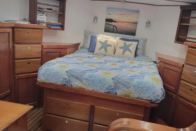 No Good Deed Yacht Photos Pics Cozy bedroom in 2007 Great Harbour N47 yacht with nautical decor and wooden cabinetry.