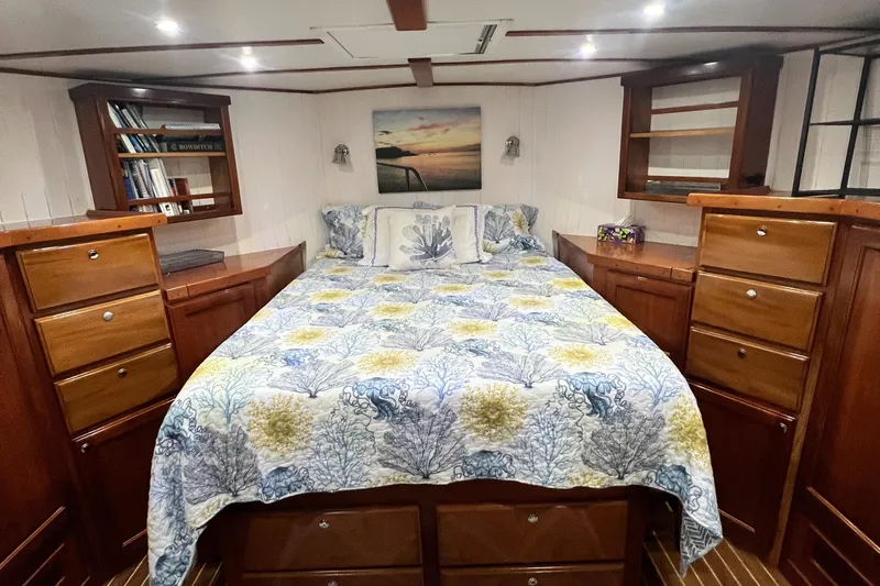 No Good Deed Yacht Photos Pics Luxurious 2007 Great Harbour N47 yacht bedroom with elegant wood cabinetry and nautical-themed bedding.