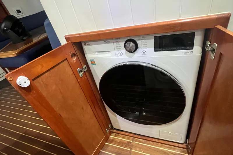 No Good Deed Yacht Photos Pics Washer-dryer unit in 2007 Great Harbour N47 yacht's wooden cabinet.