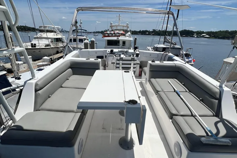 No Good Deed Yacht Photos Pics Great Harbour N47 yacht deck with seating and table, docked in a marina, 2007 model.